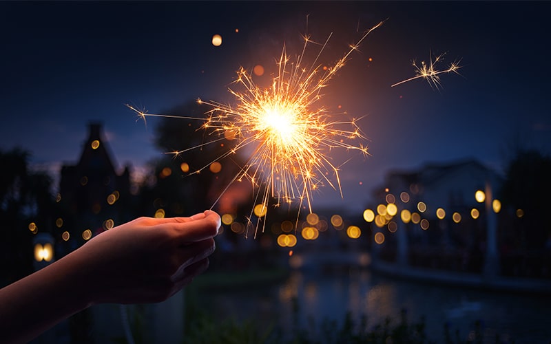 sparkler and fireworks are used in a neighborhood