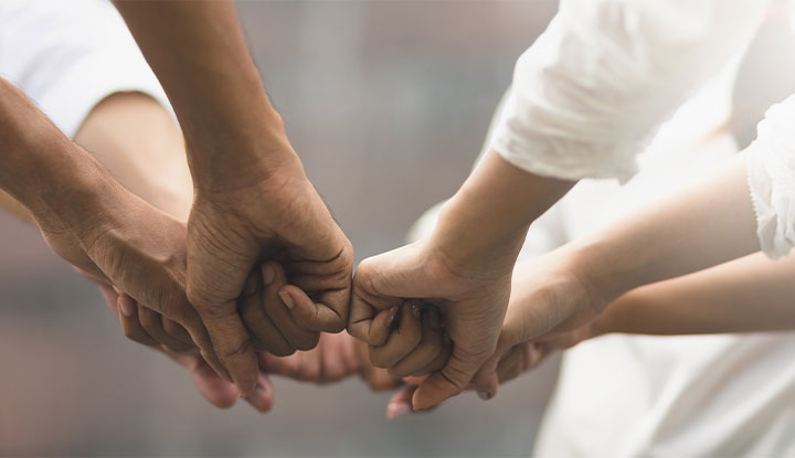 volunteers putting hands together