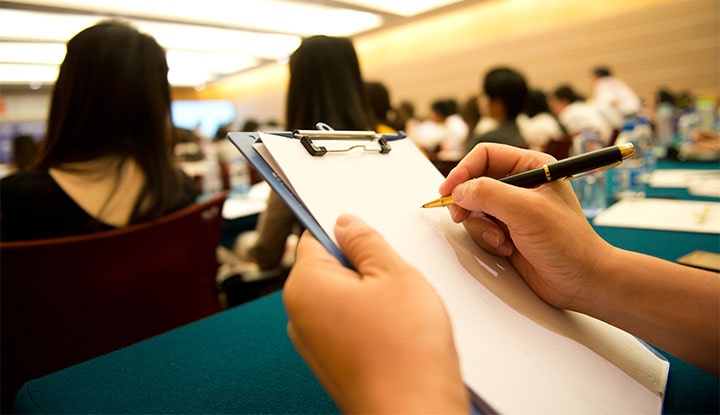 community association leader taking notes in education session