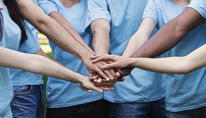 community association managers putting hands in