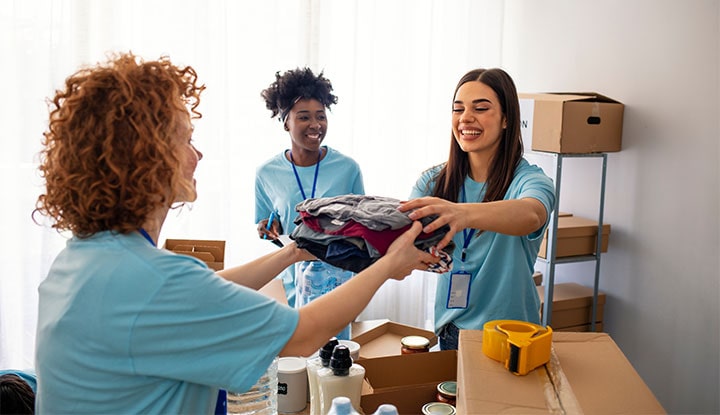 community association managers collecting clothing items for donations