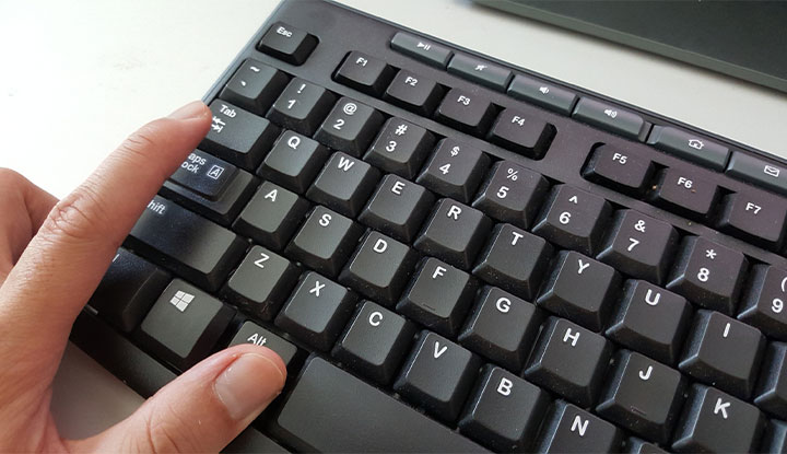 person using keyboard shortcuts to speed up task on computer