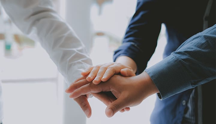business people joining hands