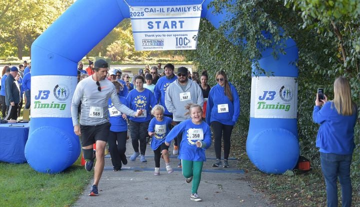CAI family members running across the finish line