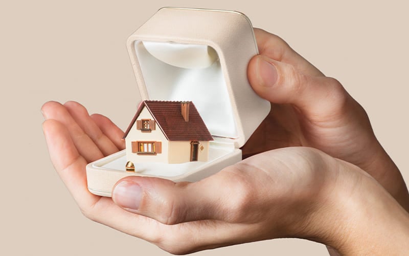 A home inside an engagement ring box