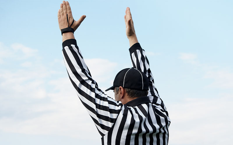 A referee calling a touchdown