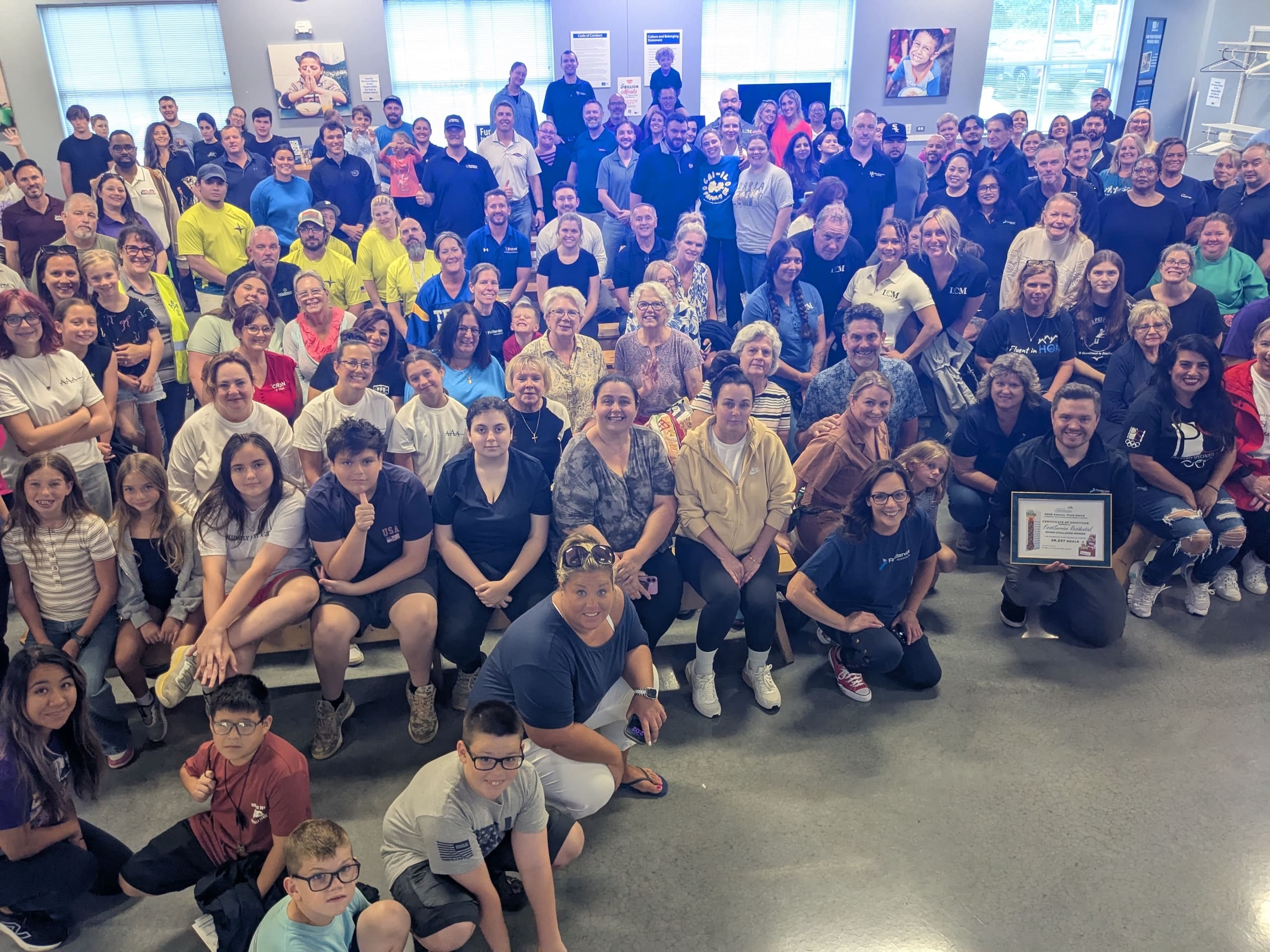 a group of people smiling at CAI Illinois's 2026 service day